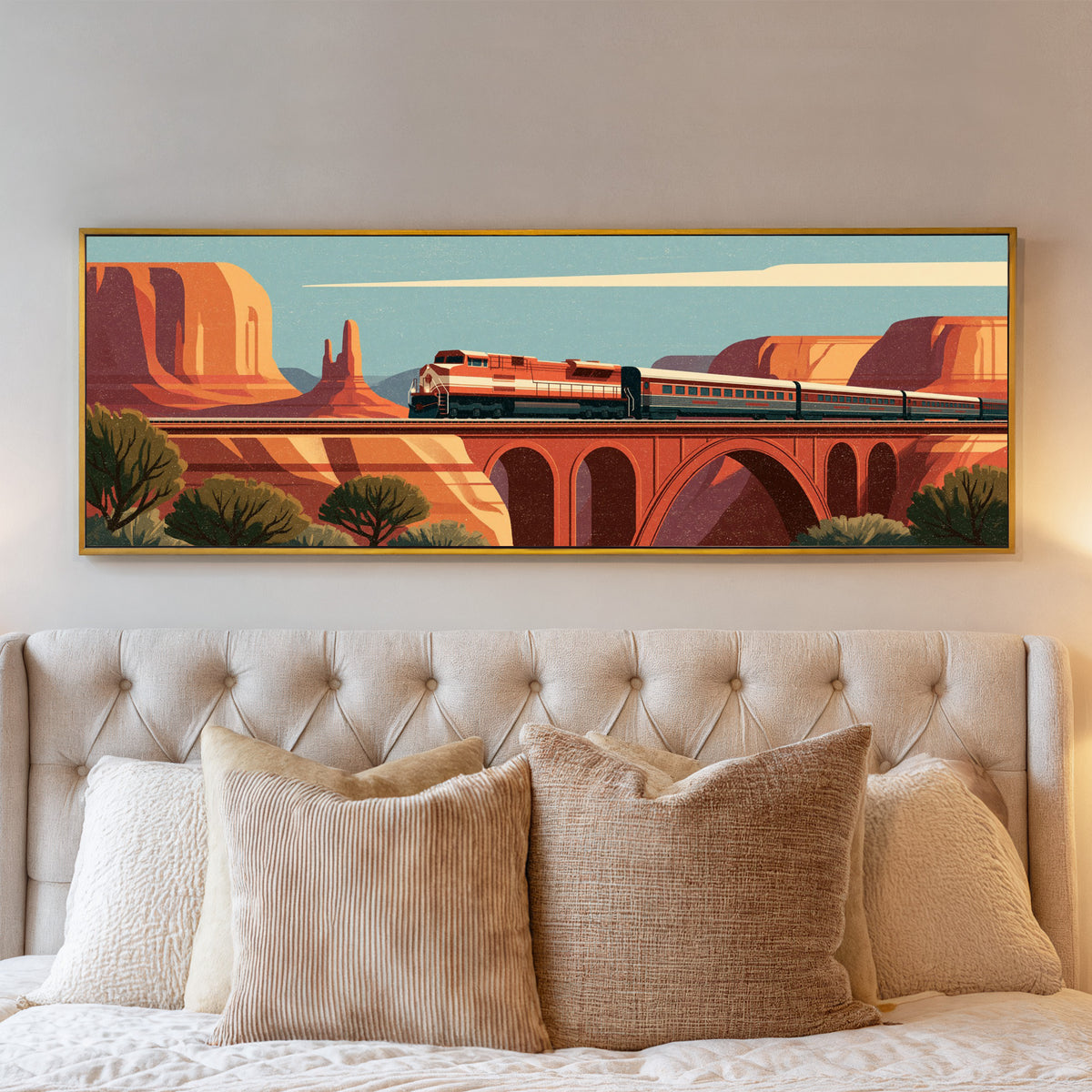 red and cream passenger train crossing an canvas wall art in a gold floater frame above a bed