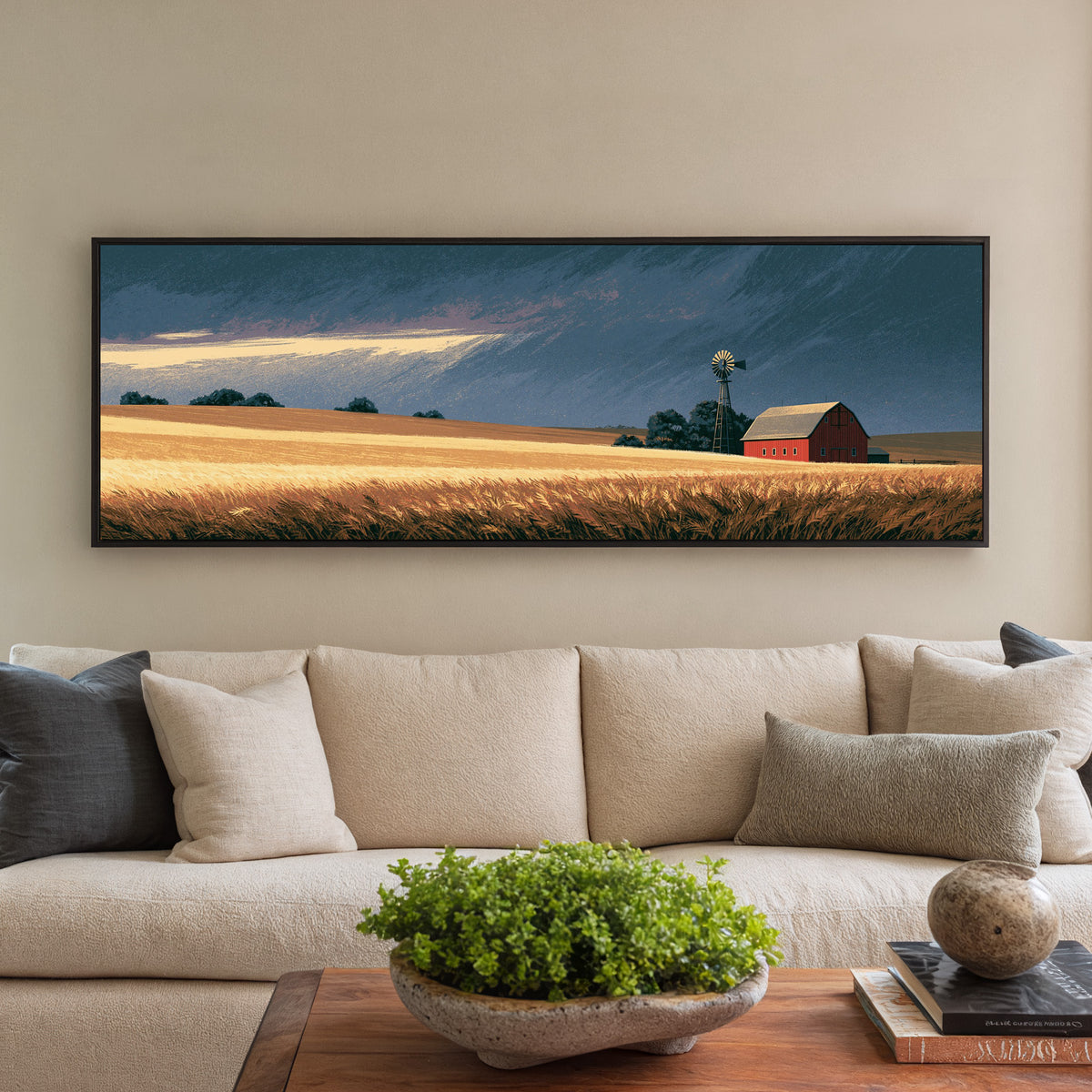red barn and windmill across golden prairie canvas wall art in a black floater frame in a styled room setting