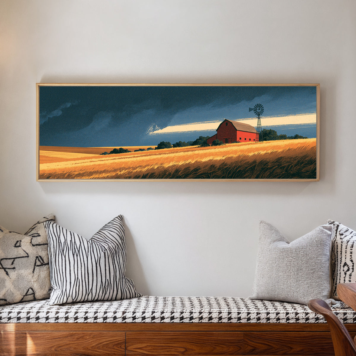 red barn and windmill above golden fields canvas wall art in a natural floater frame in a living room