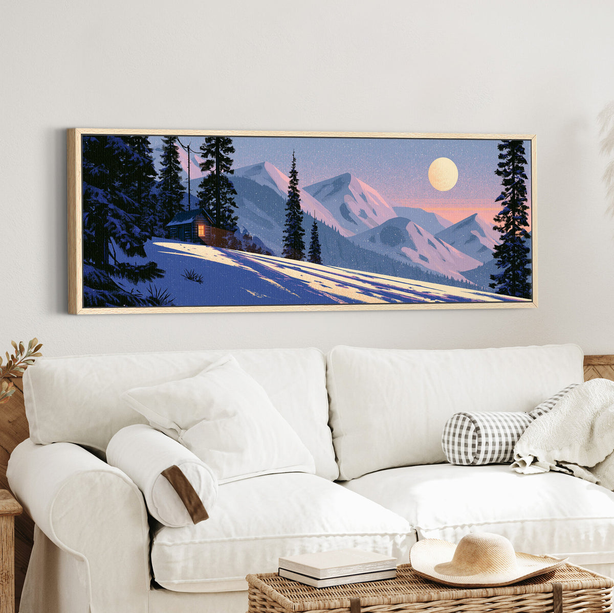 snowbound cabin beneath pink canvas wall art in an oak finish floater frame in a styled room setting
