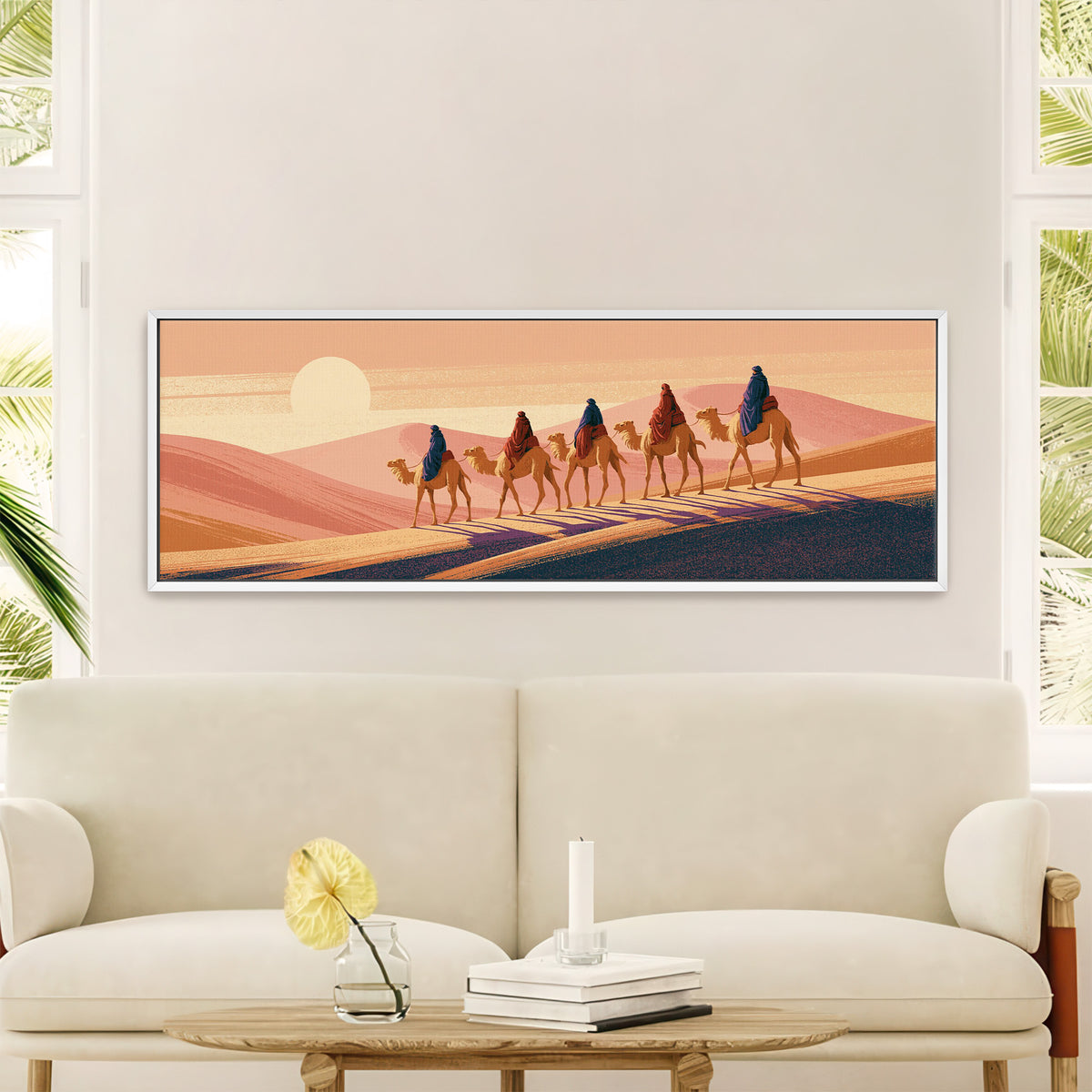 five camel riders crossing peach canvas wall art in a white floater frame in a styled room setting