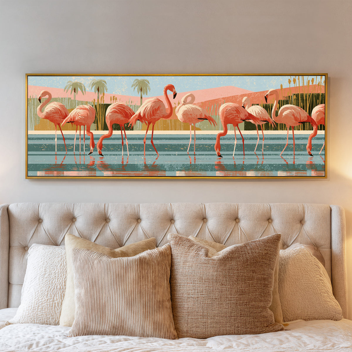 coral pink flamingos wading in striped teal canvas wall art in a gold floater frame above a bed