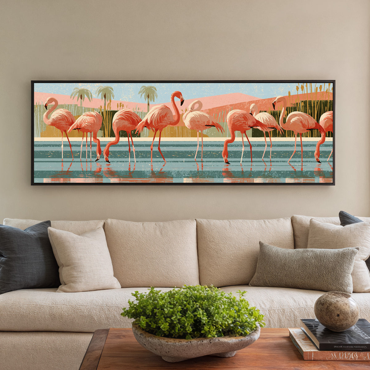 coral pink flamingos wading in striped teal canvas wall art in a black floater frame in a styled room setting