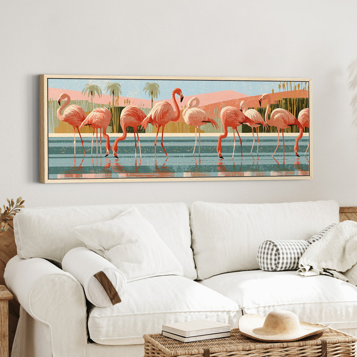 coral pink flamingos wading in canvas wall art in an oak finish floater frame in a styled room setting