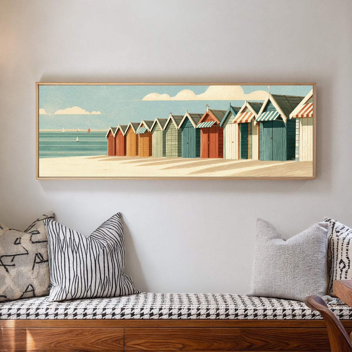 receding beach huts with striped awnings beside canvas wall art in a natural floater frame in a living room