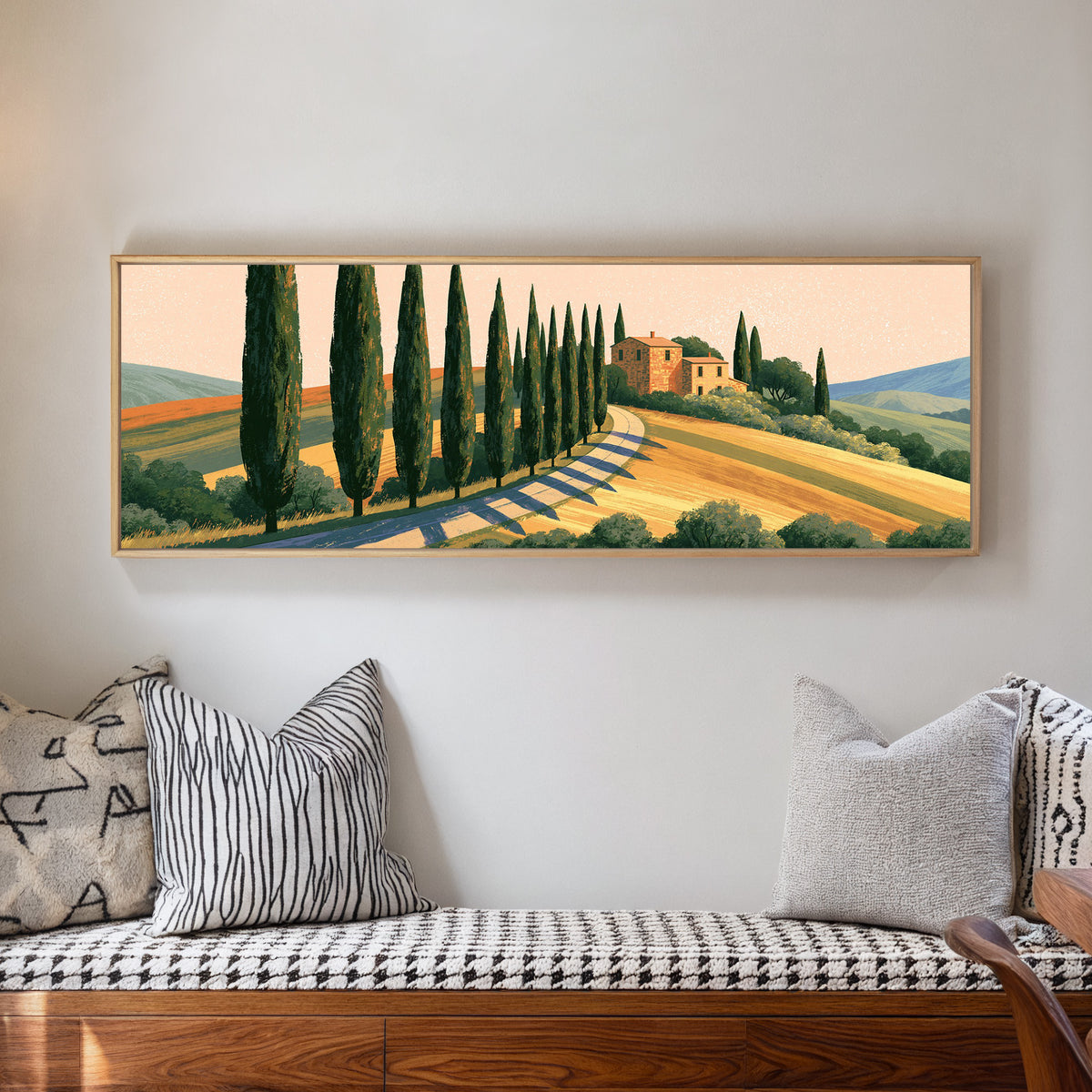 winding country road lined with tall dark trees canvas wall art in a natural floater frame in a living room
