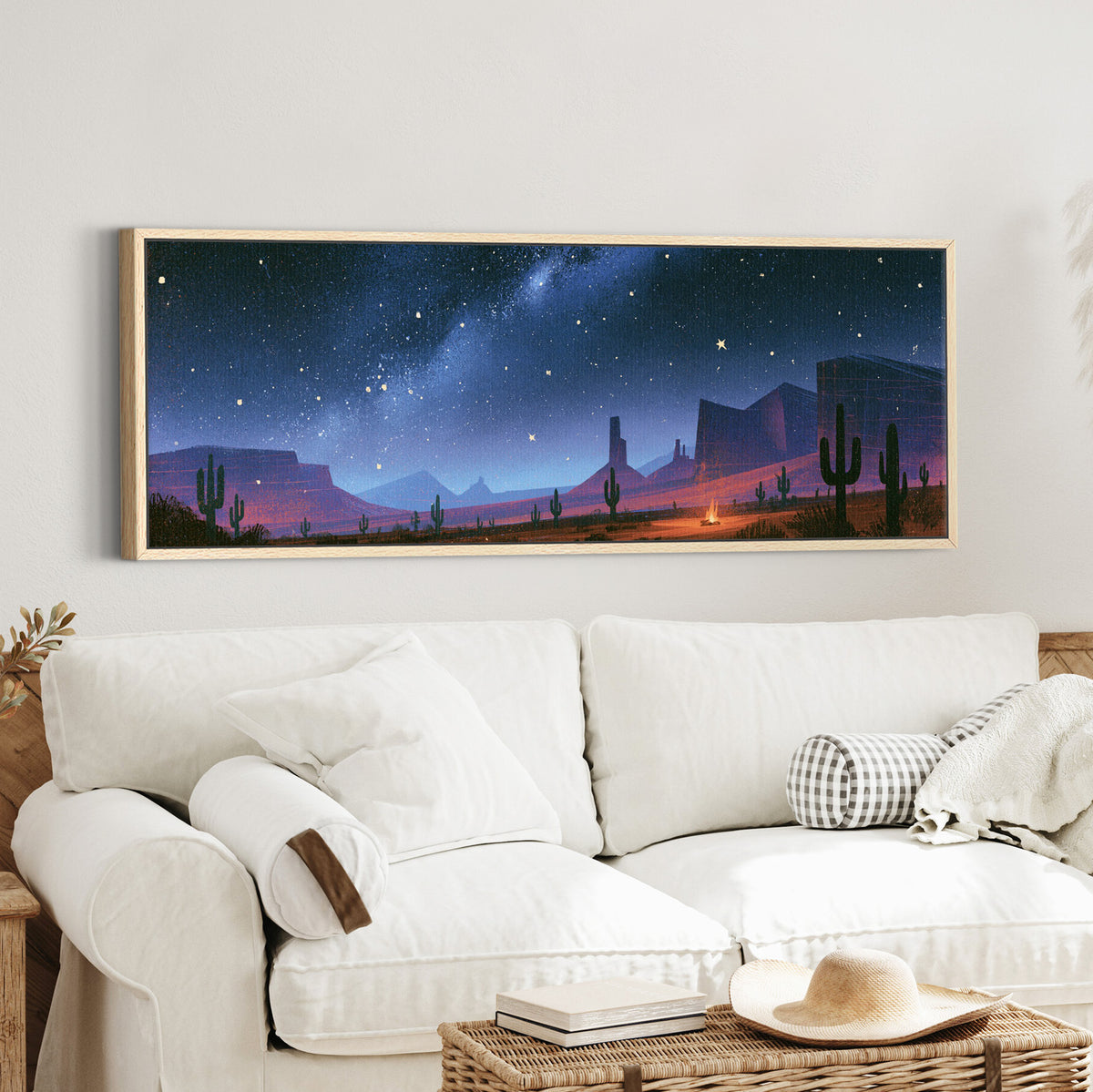 star filled blue sky above desert canvas wall art in an oak finish floater frame in a styled room setting