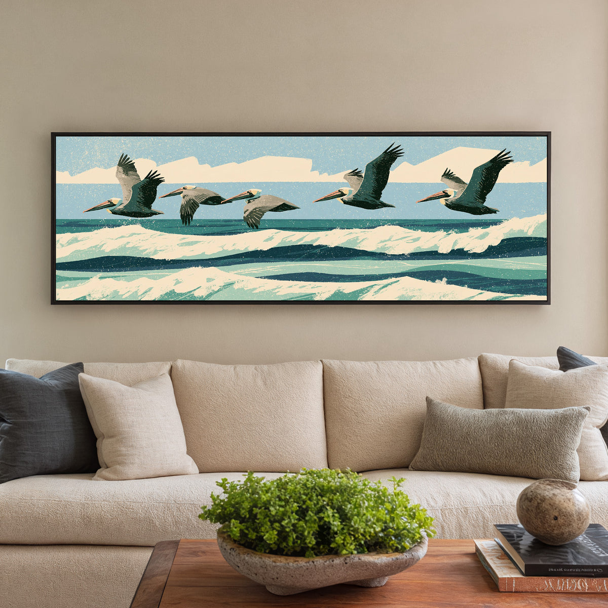 five brown pelicans flying over teal surf canvas wall art in a black floater frame in a styled room setting