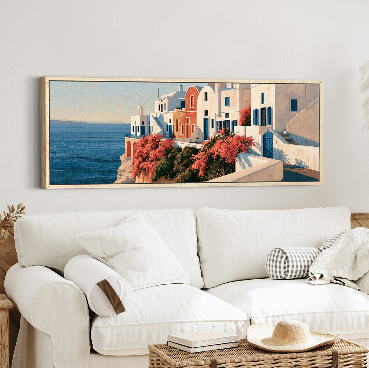 white seaside houses with blue canvas wall art in an oak finish floater frame in a styled room setting