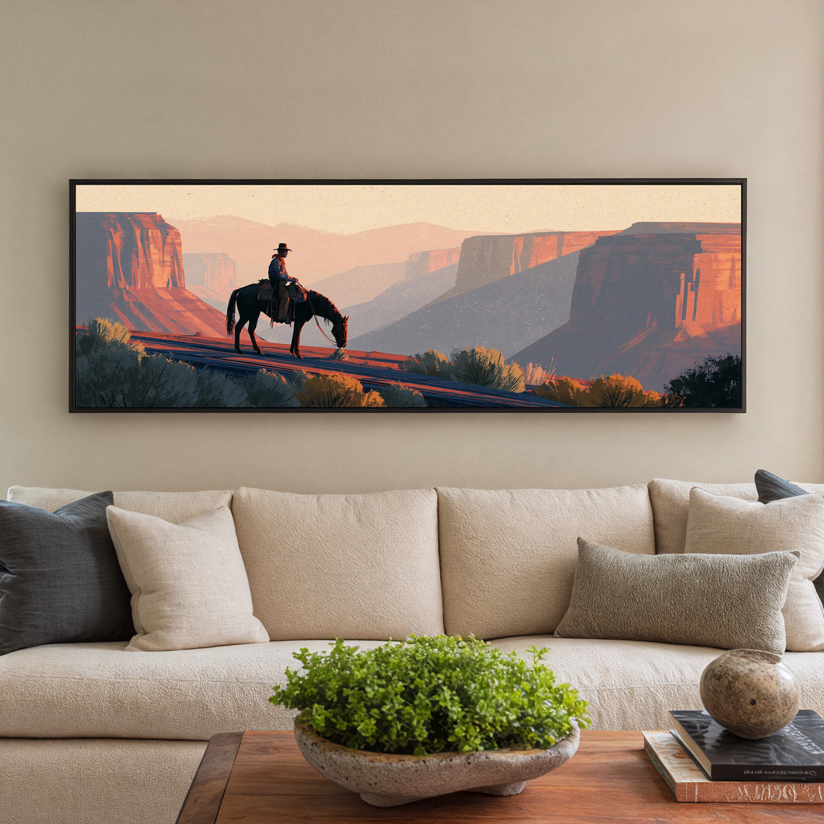lone mounted cowboy above terracotta canyon canvas wall art in a black floater frame in a styled room setting