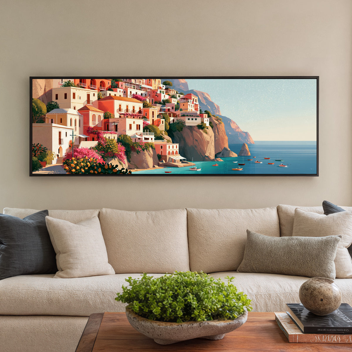 coral cliffside houses above turquoise water canvas wall art in a black floater frame in a styled room setting