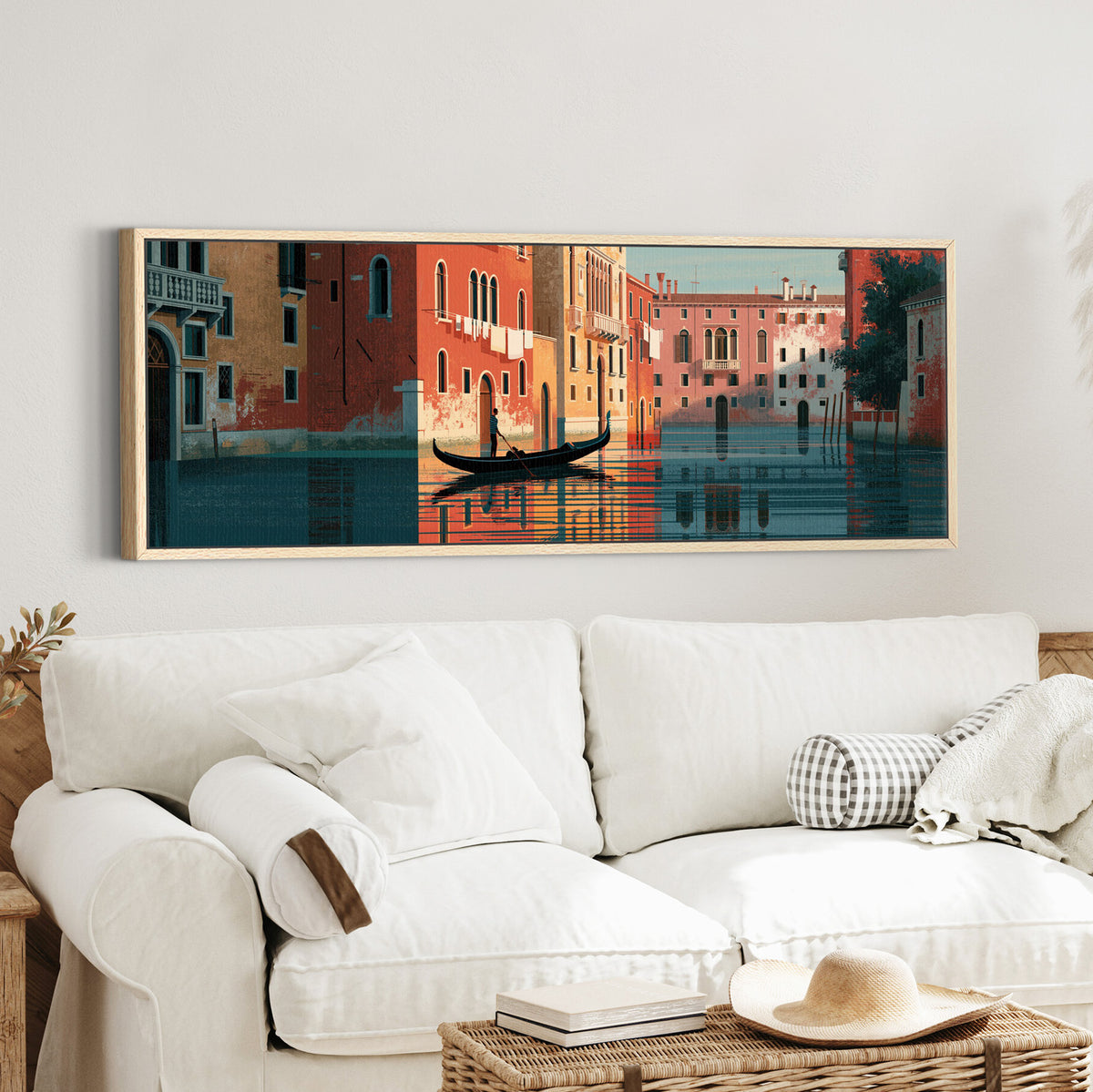 venetian gondola beneath coral canvas wall art in an oak finish floater frame in a styled room setting