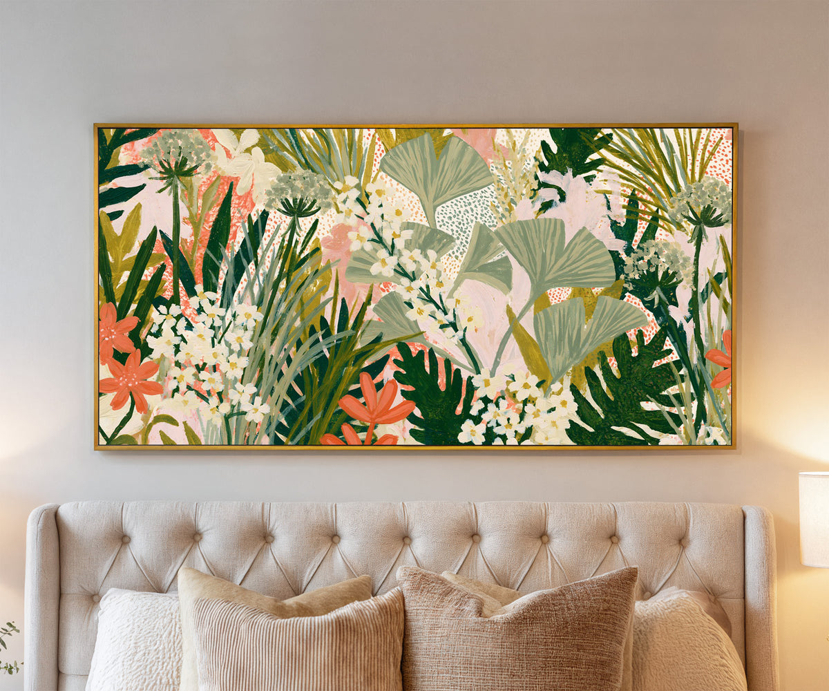 sage fan shaped leaves and white flowers over canvas wall art in a gold floater frame above a bed
