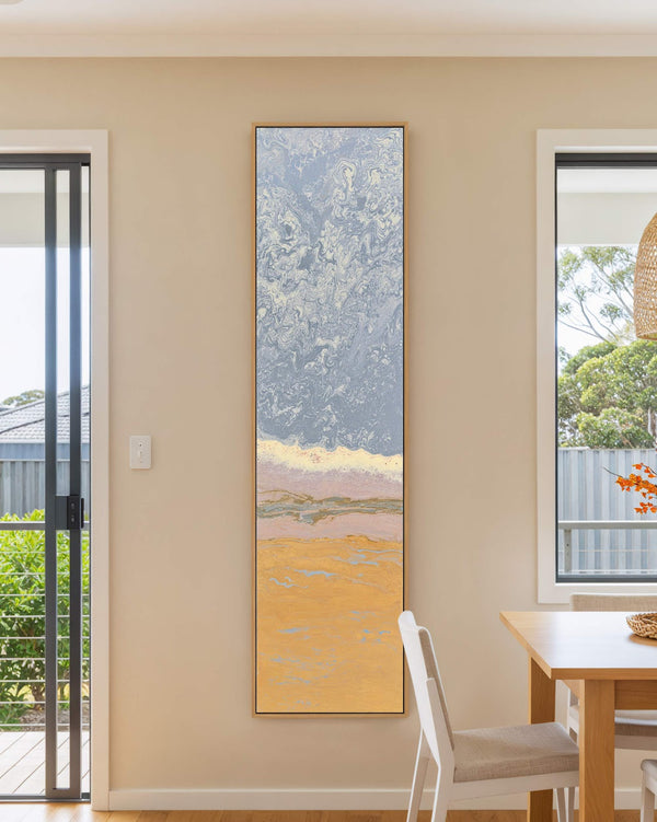 Vertical canvas wall art in interior setting.