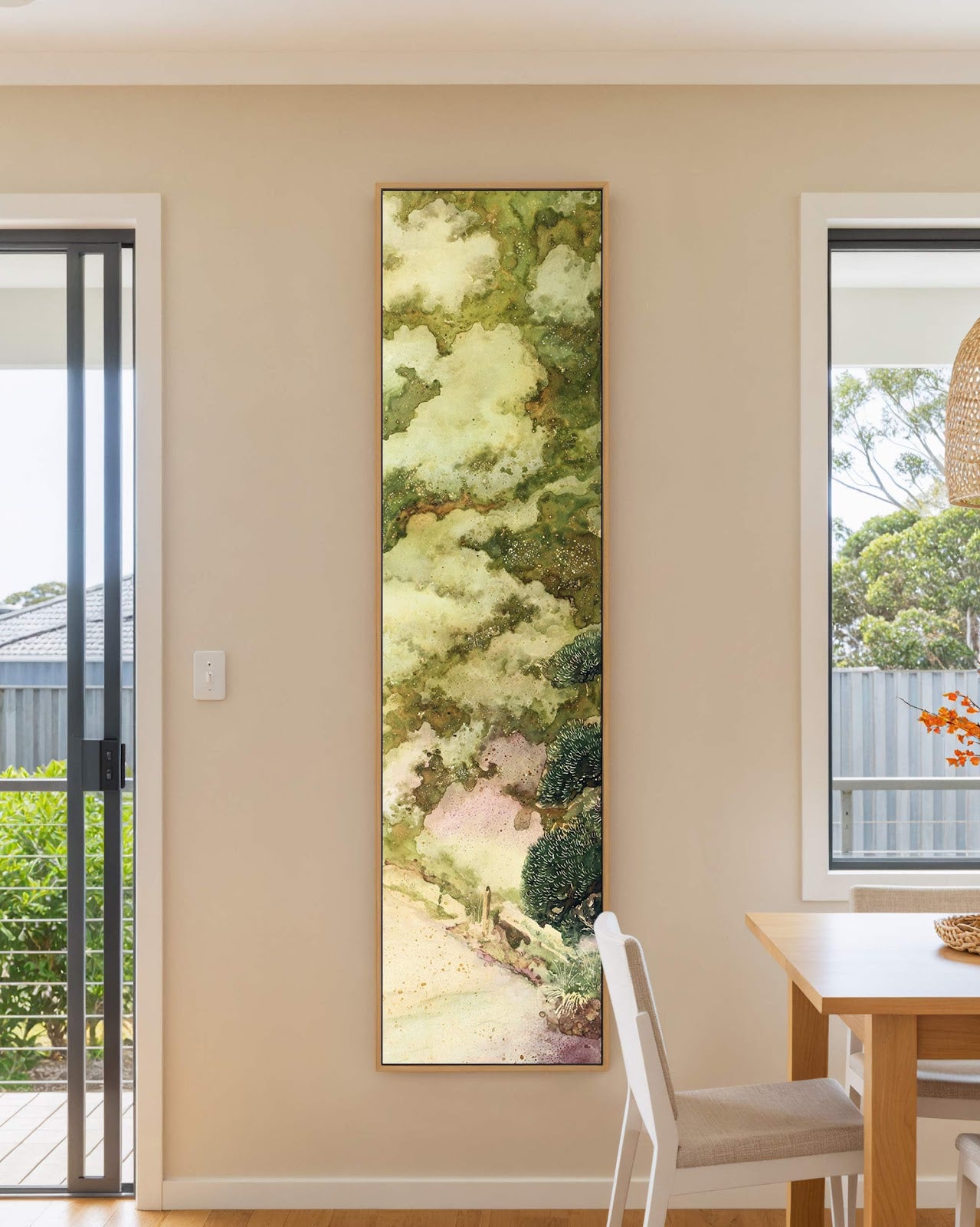 Vertical canvas wall art in interior setting.