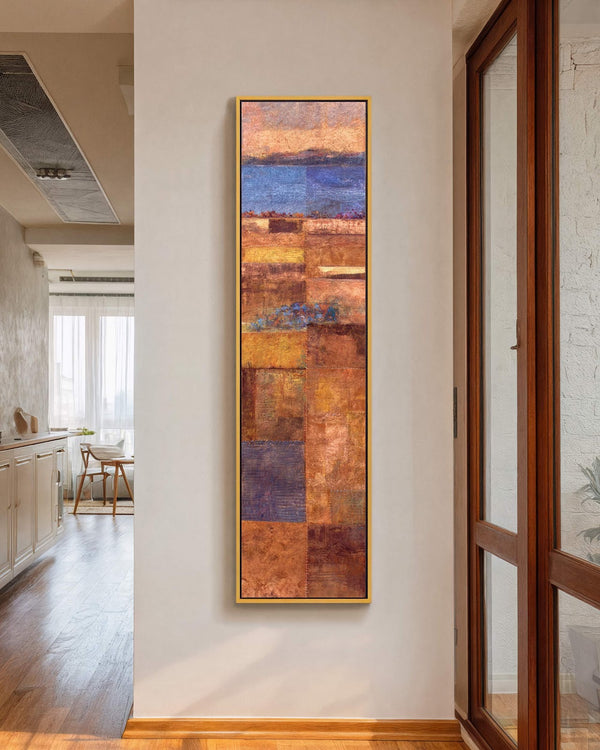Vertical canvas wall art in interior setting.