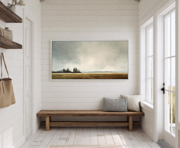 This horizontal canvas wall art features a moody landscape painting with a muted earthy palette and a soft, atmospheric style, displayed above a rustic wooden bench on shiplap walls.