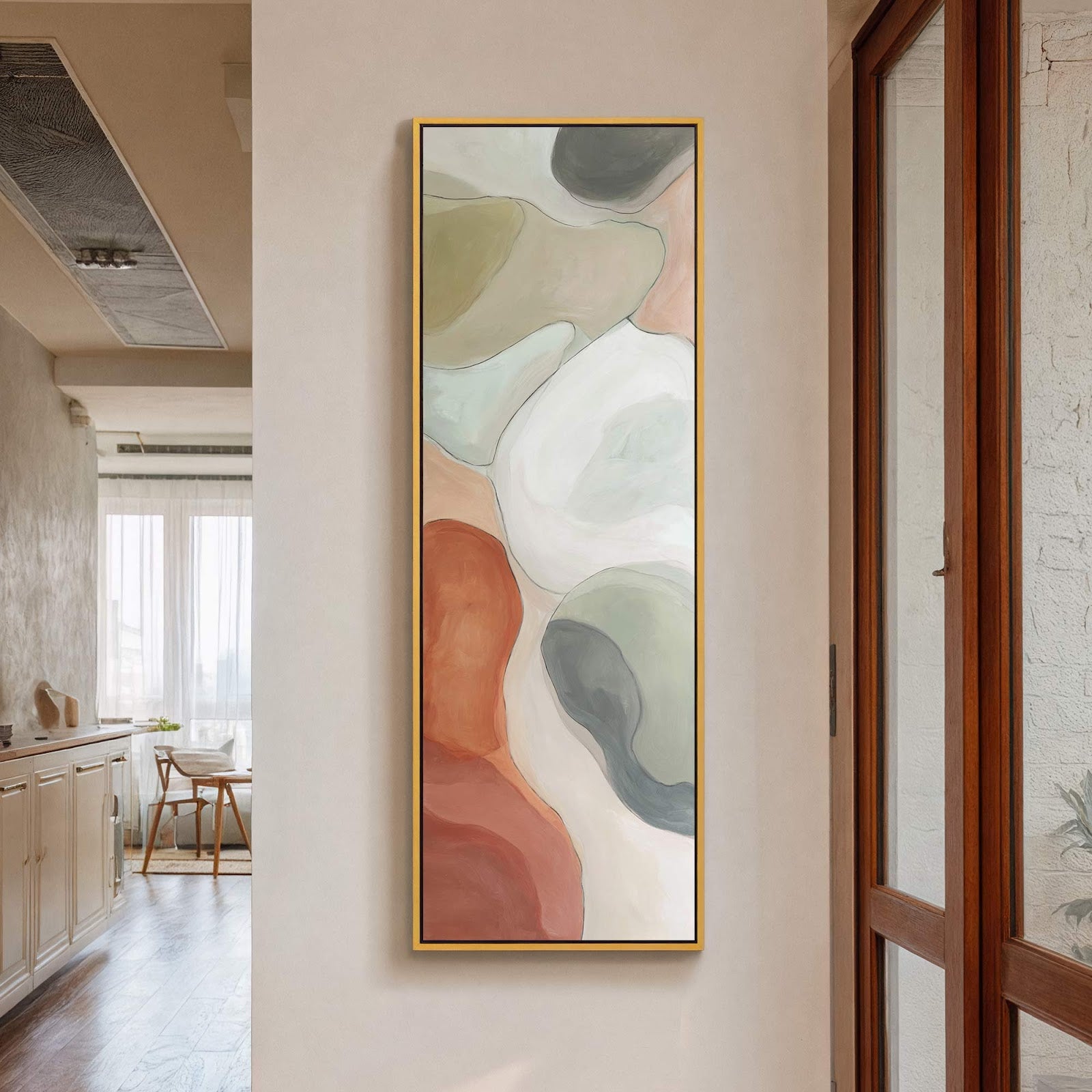 This vertical canvas print features abstract shapes in a muted palette of greens, whites, and rust orange, framed in gold, hanging on a neutral wall.
