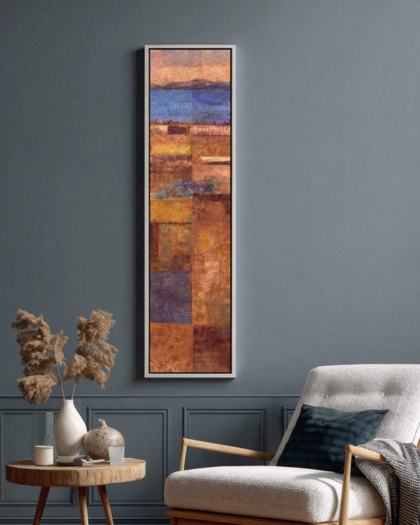 Vertical canvas wall art in interior setting.