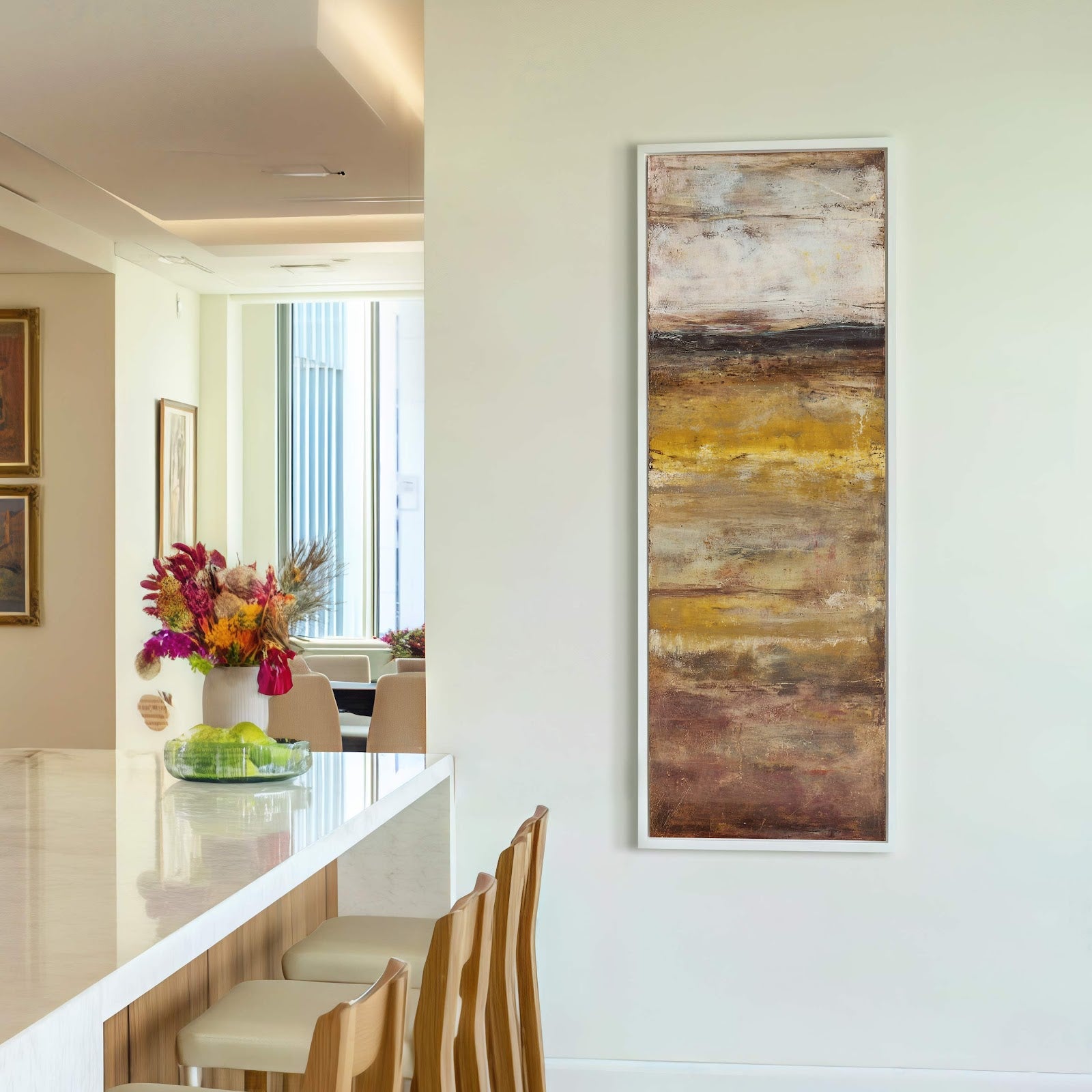 This vertical canvas wall art features an abstract landscape with a warm, earthy palette and a textured style, hanging on a white wall above a console table.