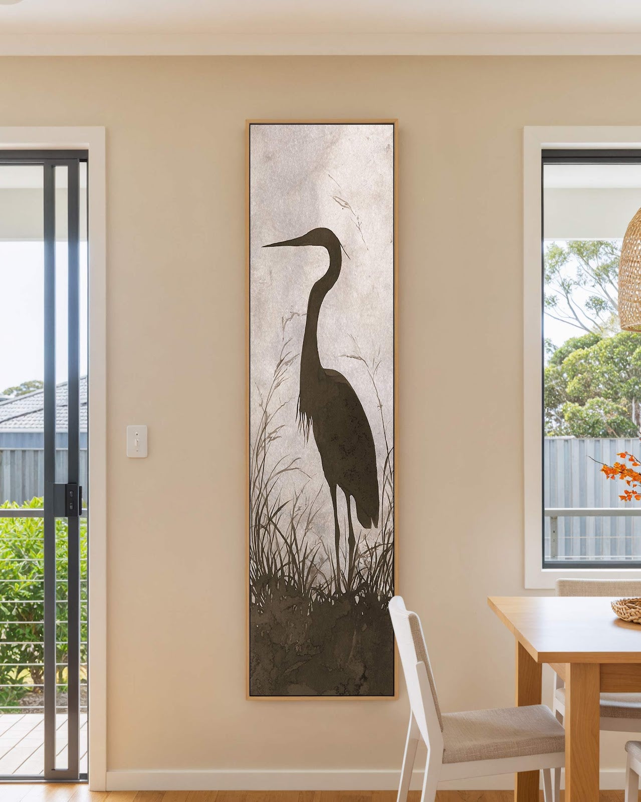 Vertical canvas wall art in interior setting.