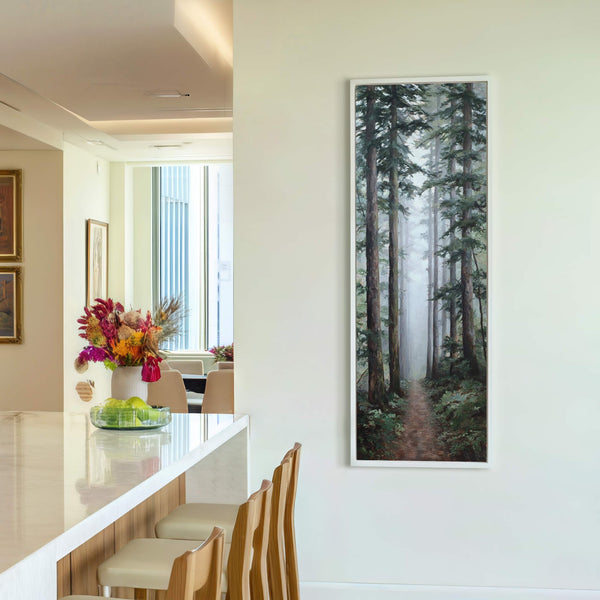 This vertical canvas wall art depicts a misty forest path with tall trees and lush green foliage, rendered in a realistic style with a cool, natural palette, hanging on a.