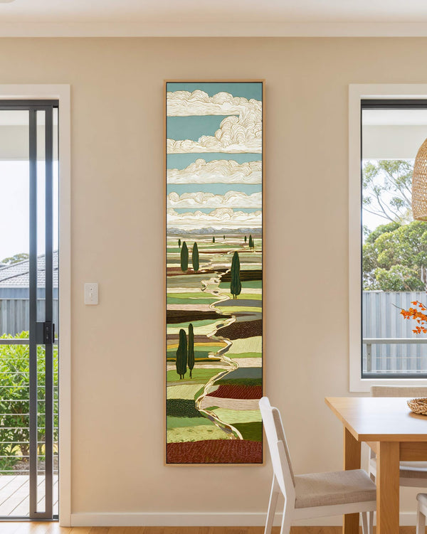 Vertical canvas wall art in interior setting.