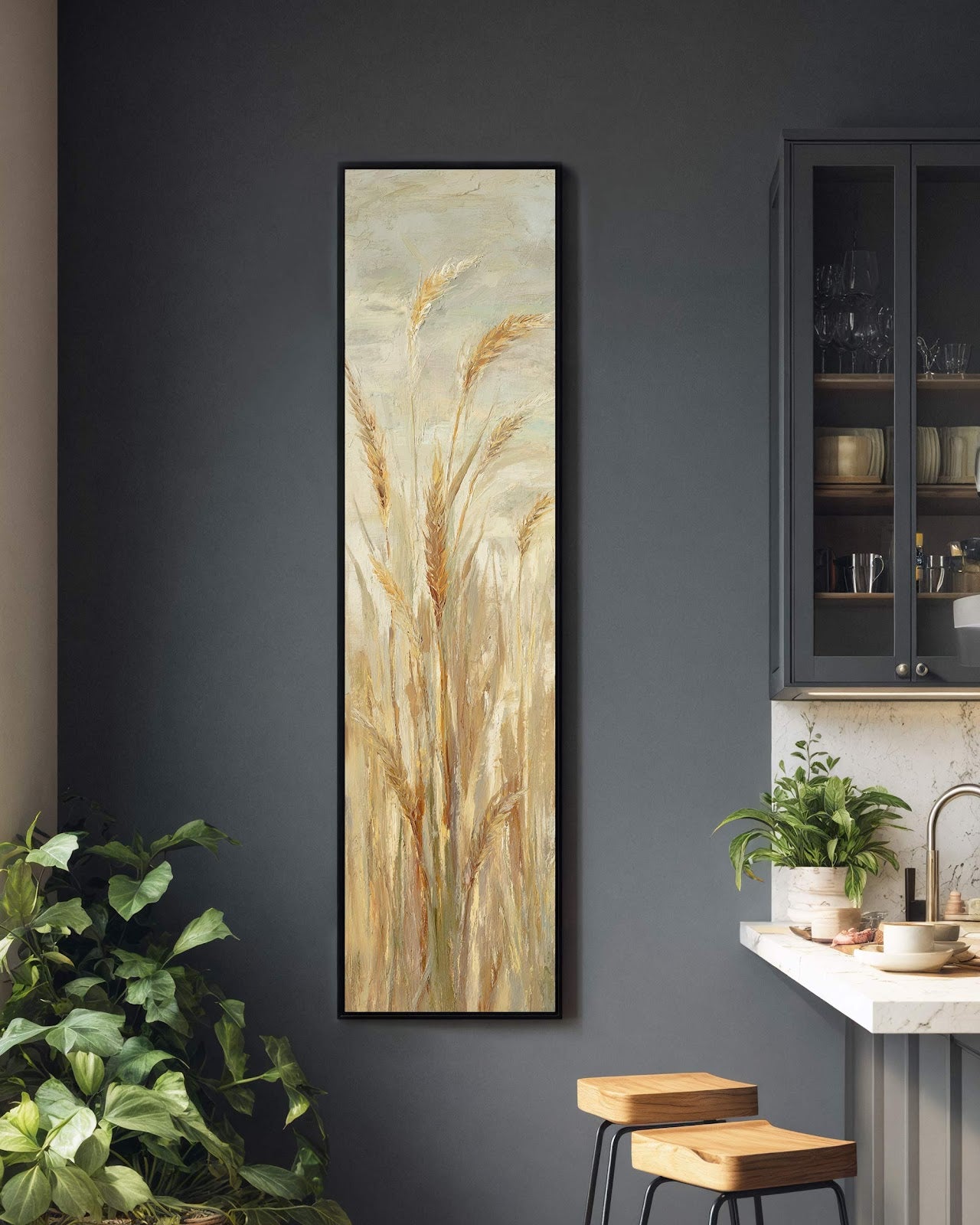 This vertical canvas wall art features impressionistic golden wheat in a black floater frame, displayed on a dark grey kitchen wall beside a glass-door cabinet.