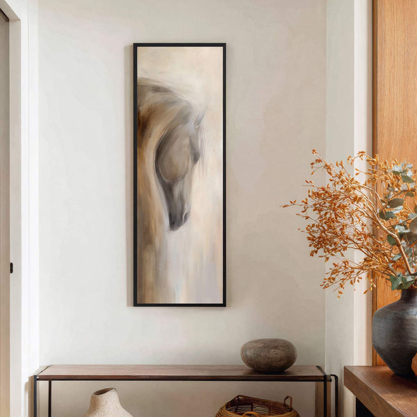 This vertical canvas wall art features an abstract, impressionistic painting of a horse's head in a neutral palette of browns and creams, framed in black, and displayed in a room.