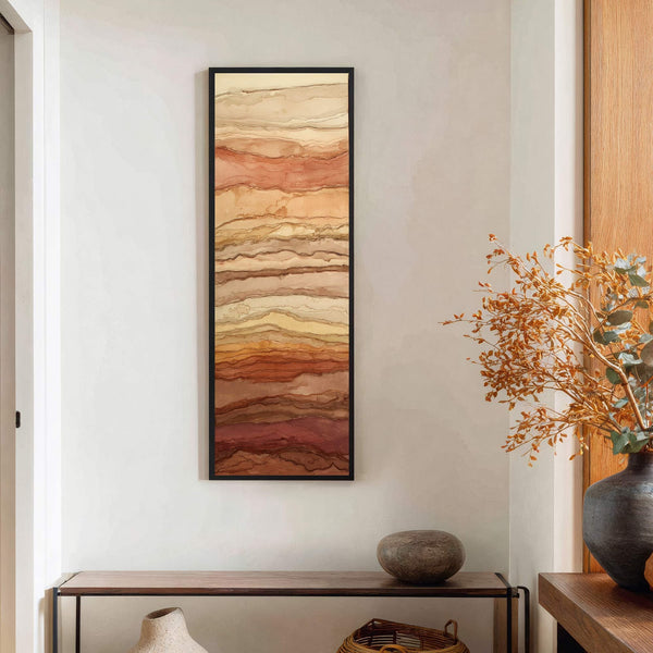 This vertical canvas wall art features abstract earthy tones in a layered, naturalistic style, set against a white wall with a console table below.