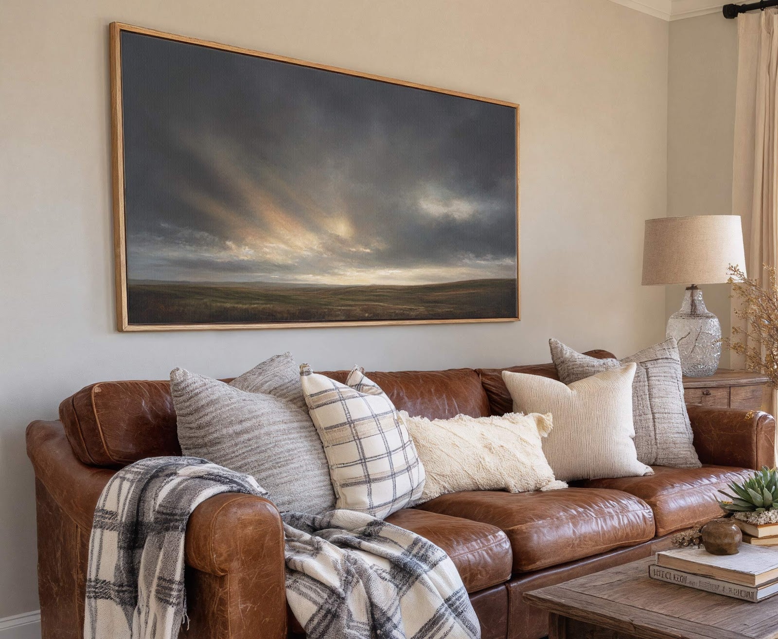 This horizontal canvas wall art features a dramatic, moody landscape under a stormy sky with shafts of light breaking through. The artwork is framed with a natural wood floater frame.