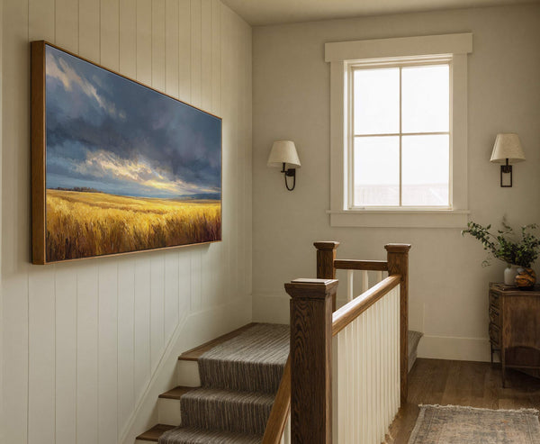 This horizontal canvas print displays a landscape painting of a golden field under a dramatic, cloudy sky with golden light, rendered in a painterly style with a warm palette. It.