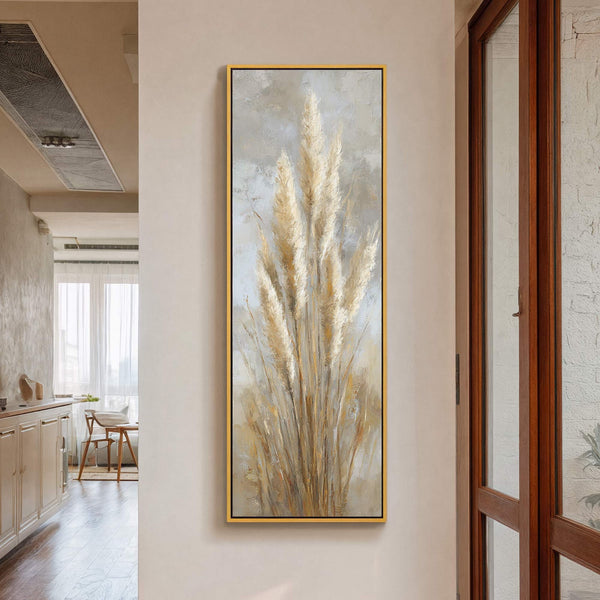 This vertical, impressionistic canvas wall art print features a cluster of pampas grass in a muted, earthy palette against a soft gray textured background, framed in gold.