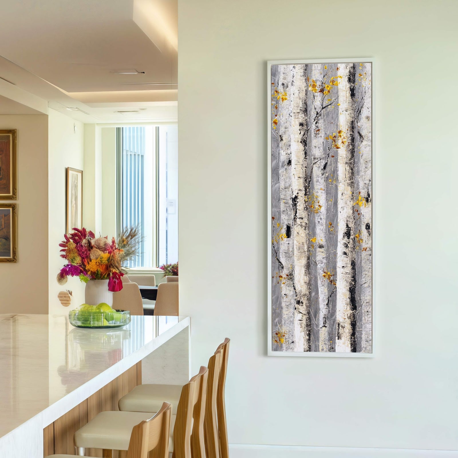This vertical canvas wall art features an abstract birch tree bark design with a textured palette of grays, black, and yellow accents, framed in white and displayed on a pale.