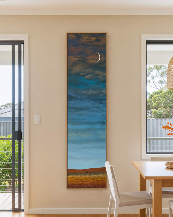 Vertical canvas wall art in interior setting.