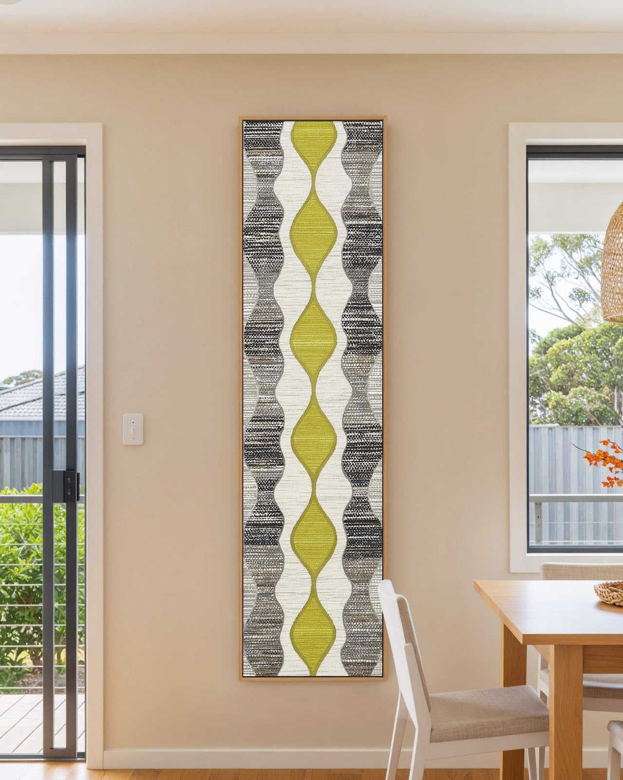 Vertical canvas wall art in interior setting.