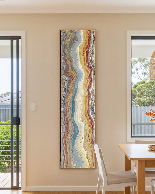 Vertical canvas wall art in interior setting.