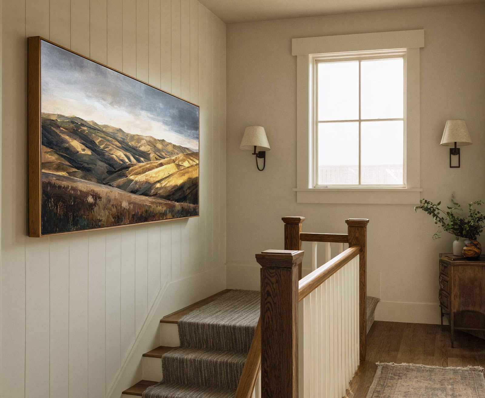 This horizontal canvas wall art depicts rolling hills in a painterly style with a palette of earthy browns and muted blues, framed in natural wood and hung on a wall.