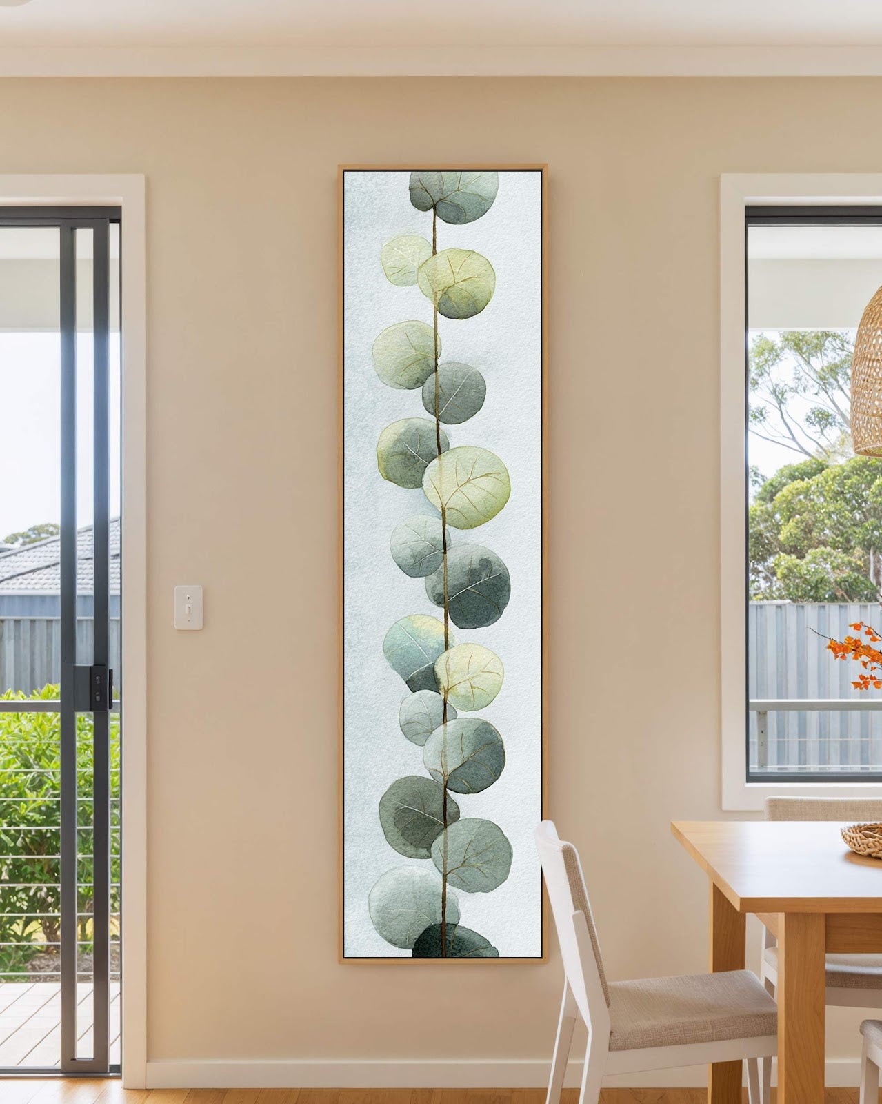 Vertical canvas wall art in interior setting.