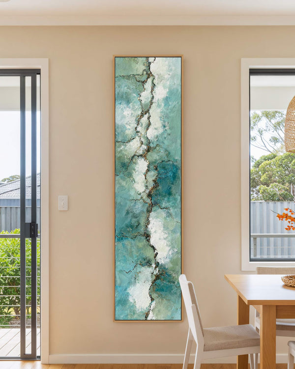 Vertical canvas wall art in interior setting.