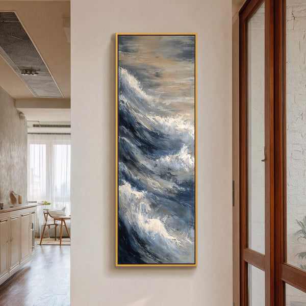 A vertical canvas wall art print showcases an abstract depiction of crashing waves, rendered in a palette of deep blues, grays, and whites, with impasto texture. The artwork is framed.