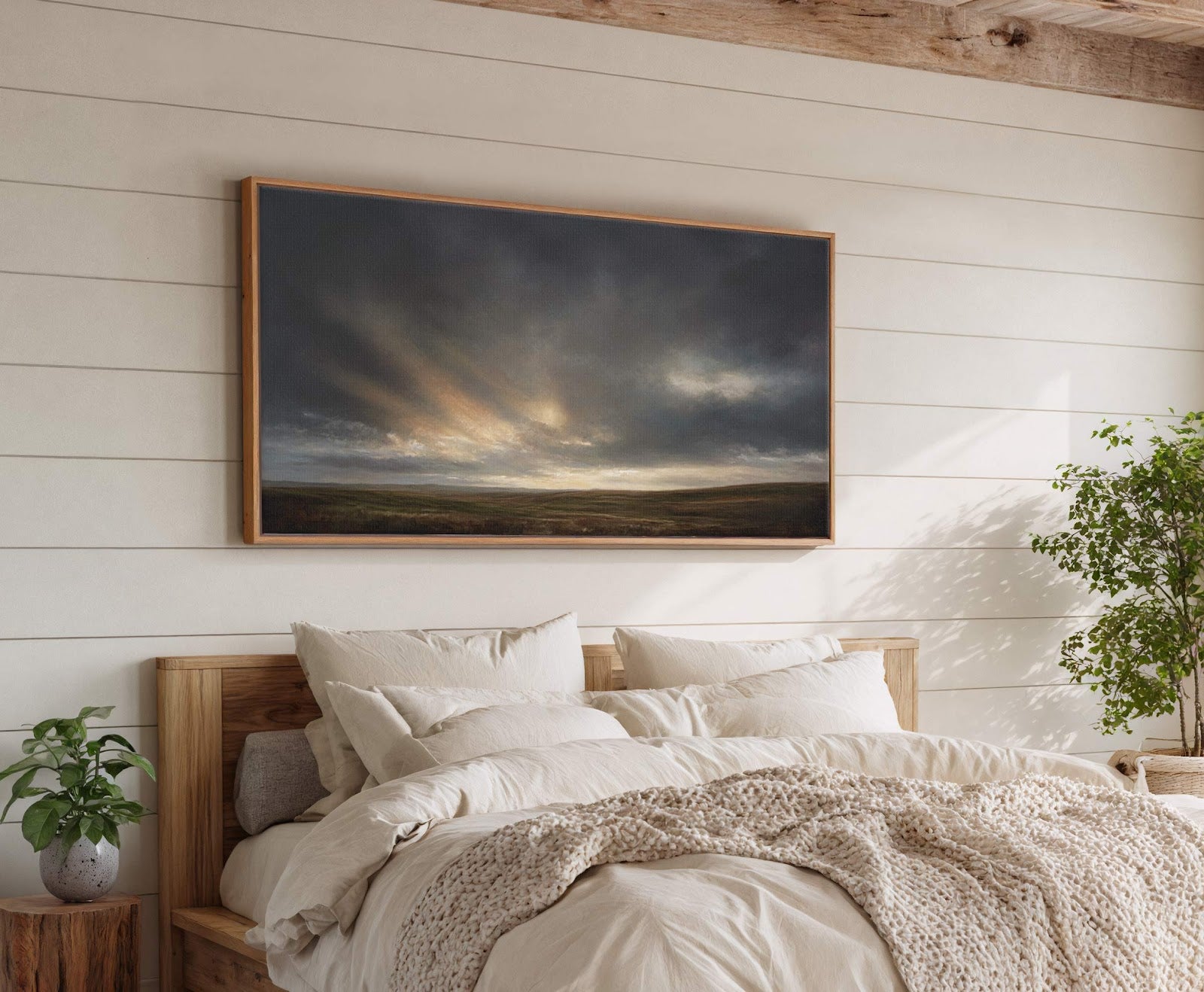 This horizontal canvas wall art features a dramatic landscape with dark, cloudy skies and shafts of light breaking through over rolling hills, rendered in a painterly style with a muted.