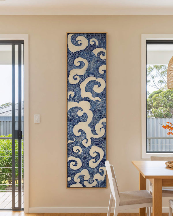 Vertical canvas wall art in interior setting.