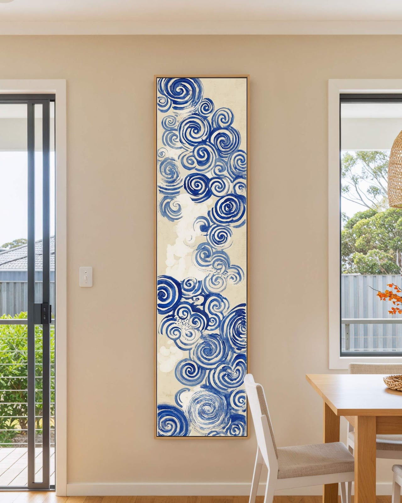 Vertical canvas wall art in interior setting.