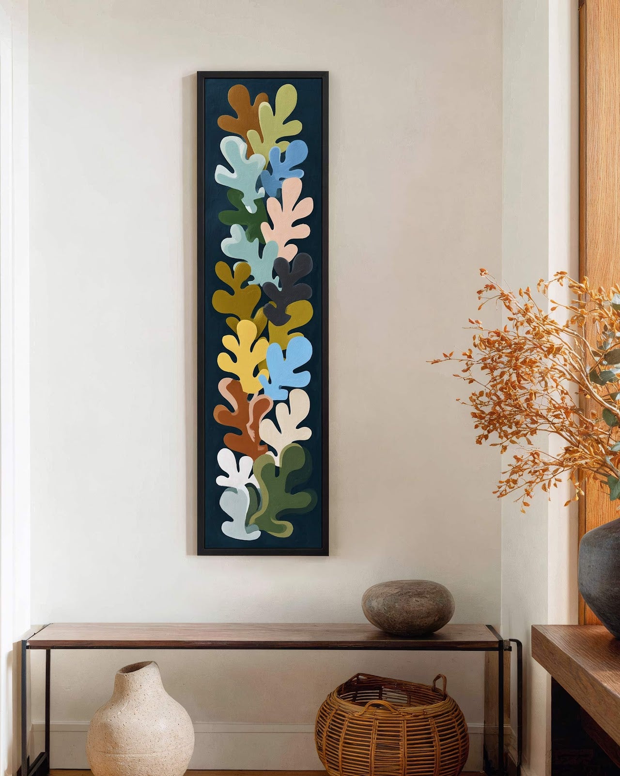 Vertical canvas wall art in interior setting.