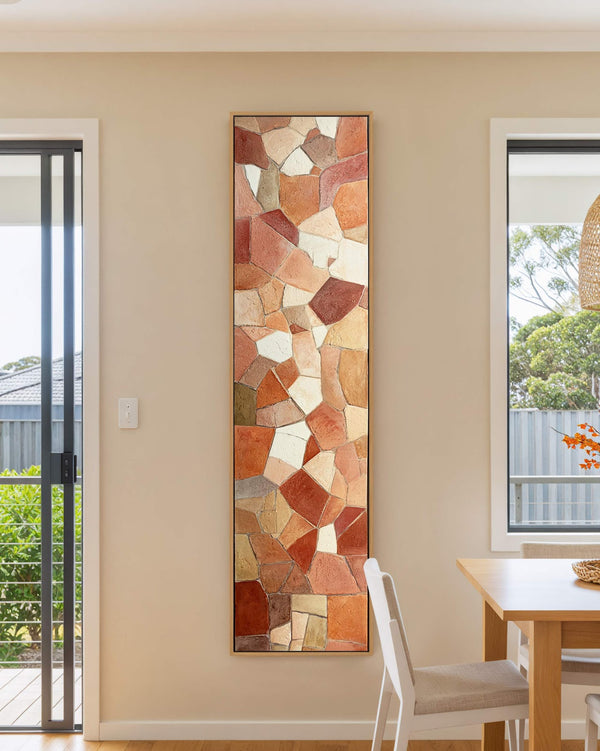 Vertical canvas wall art in interior setting.