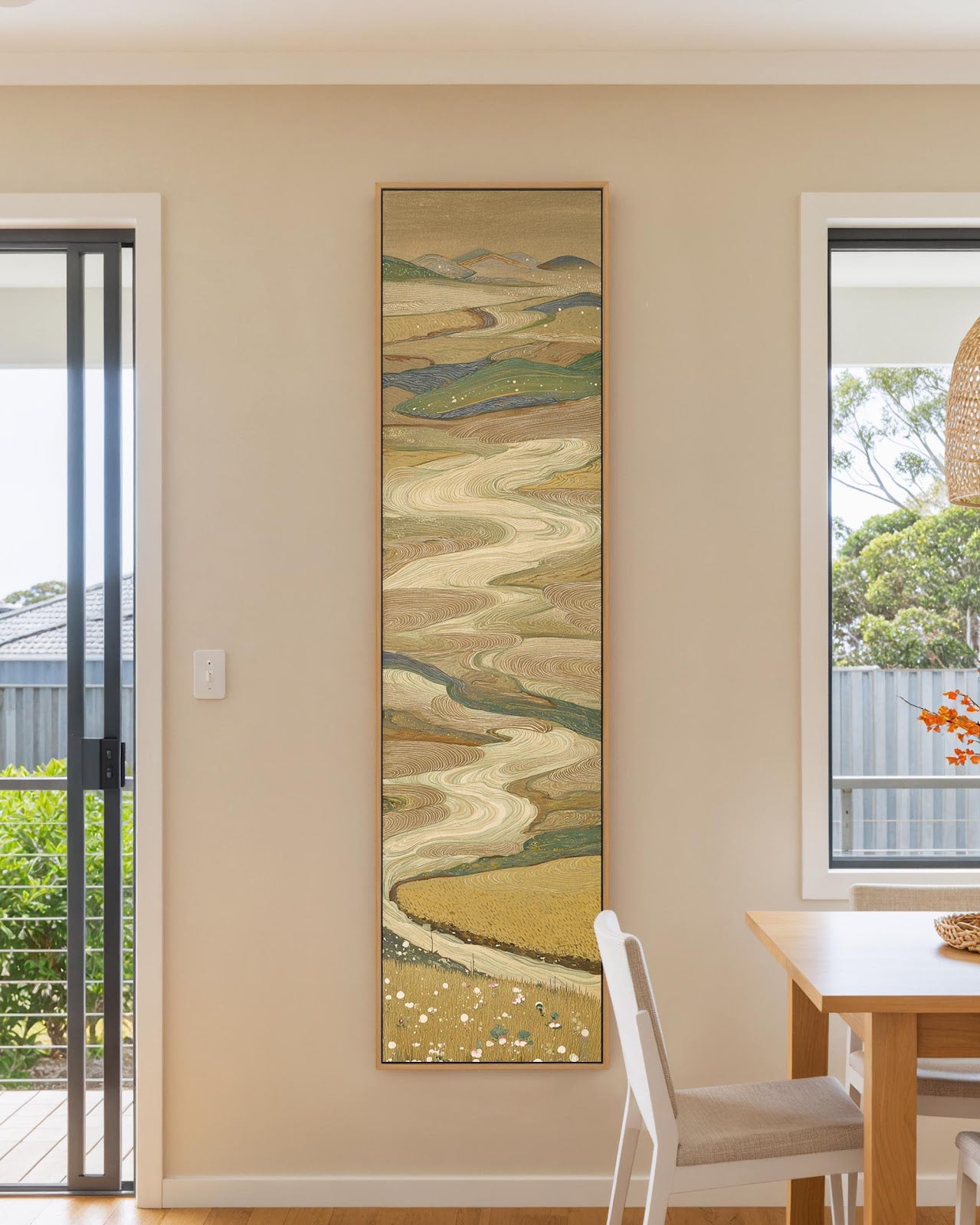 Vertical canvas wall art in interior setting.