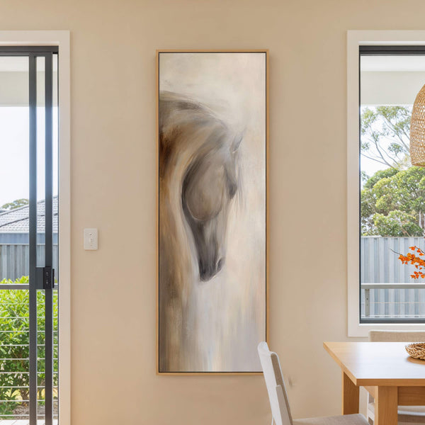 This vertical, impressionistic canvas wall art features a horse's head rendered in a muted palette of browns, grays, and creams, set against a beige wall next to a window and.