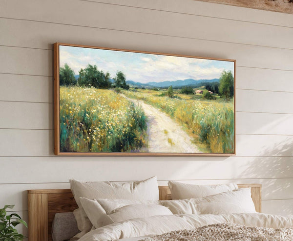 This horizontal canvas wall art depicts a country road winding through a meadow filled with wildflowers and trees, rendered in a loose, painterly style with a warm, natural palette. It.