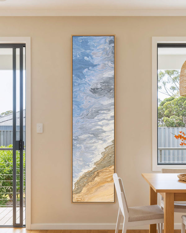 Vertical canvas wall art in interior setting.